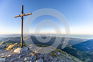 Cross at sunrise on the summit of Mountain peak of mount Pania on the Apuan Alps Alpi Apuane, Tuscany, Lucca photo