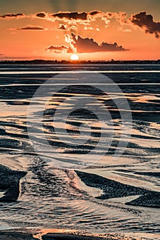 Sunrise on the sea at the Baie de Somme at low tide