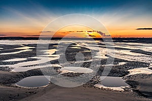 Sunrise on the sea at the Baie de Somme at low tide