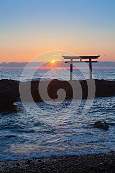 Sunrise and sea at Japanese shinto gate