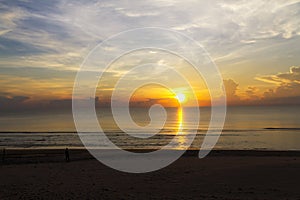 Sunrise on sea and shadow on baech at beach