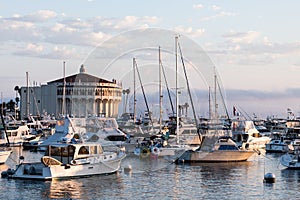 Sunrise seascape in Avalon harbor looking toward the Casino with sailboats, fishing boats and yachts moored in calm bay