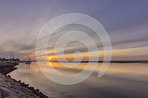 Sunrise seascape view of Olhao Marina, waterfront to Ria Formosa. Algarve.