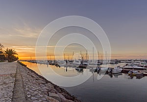 Sunrise seascape view of Olhao Marina, waterfront to Ria Formosa natural park. Algarve