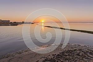 Sunrise seascape view of Olhao salt marsh Inlet, waterfront to Ria Formosa natural park. Algarve.