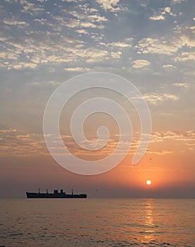 Sunrise at seaside with a shipwreck