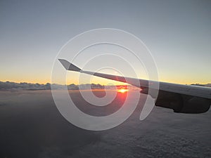 Sunrise seen from aircraft above the Clouds