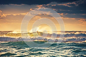Sunrise and shining waves in ocean