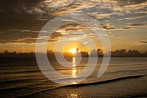 Sunrise shot over the sea and beautiful cloud. sun disappeared behind a big cloud over ocean