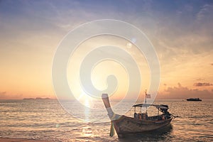Sunrise sky background concept: Traditional Thai long tail boat at beautiful sunrise background