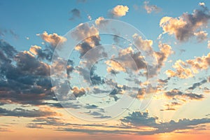 Sunrise sky with gentle colors of soft clouds and sun rays