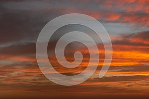 Sunrise sky with red color fire on a cloudy winter day. Space for text