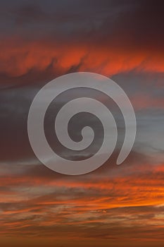 Sunrise sky with red color fire on a cloudy winter day. Space for text