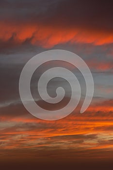 Sunrise sky with red color fire on a cloudy winter day. Space for text