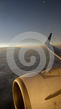 Sunrise sky view and airplane engines shot from airplane window