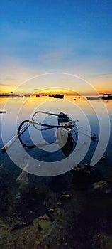 Sunrise and small fishing boats at Mertasari beach Sanur