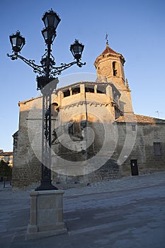 Sunrise in square on May 1, with side front and source of the church of San pablo and lamppost, Ubeda