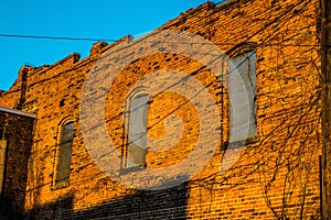 Sunrise strikes the old brick building face