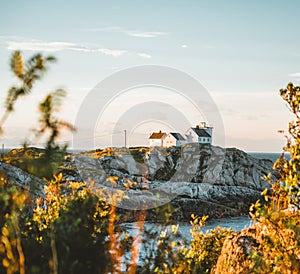 Sunrise and Sunset at Henningsvaer lighthouse with pink sky. The small fishing village located on several small islands