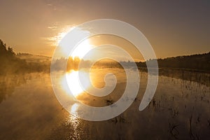 Sunrise or sunset on the lake with fog and steam