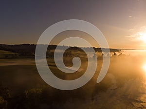 Sunrise or sunset on the lake with fog and steam