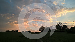 Sunrise or sunset over the hills and meadow.