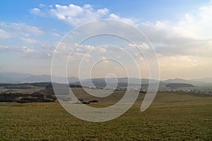 Sunrise or sunset over the hills and meadow.