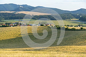 Sunrise or sunset over the hills and meadow.