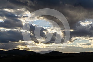 Sunrise or sunset over the hills and meadow.