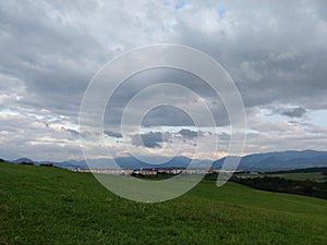 Sunrise or sunset over the hills and meadow.