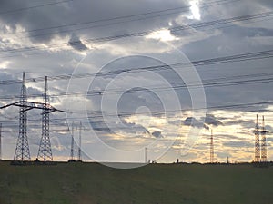 Sunrise or sunset over the hills and meadow.