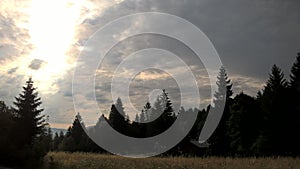 Sunrise or sunset over the hills and meadow.