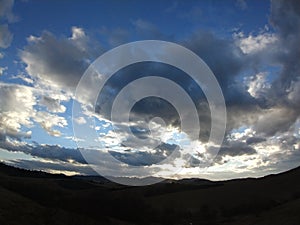 Sunrise or sunset over the hills and meadow.