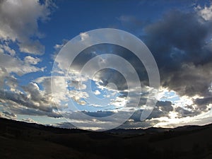 Sunrise or sunset over the hills and meadow.