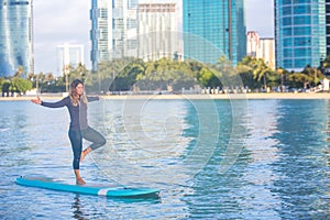 Sunrise SUP Yoga practice in Waikiki tree pose