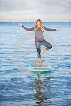 Sunrise SUP Yoga practice in Waikiki tree pose