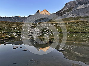 Sunrise Symphony: Peaks Panorama Lake in Vanoise National Park, Hautes Alps, France