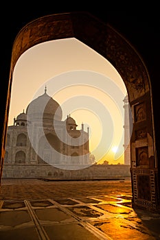 Sunrise of Taj Mahal through an archway in Agra India shot in high iso.