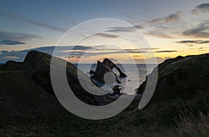 Sunrise time by the Bow Fiddle Rock in Scotland