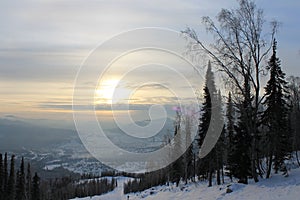 Sunrise on top of a mountain with slopes for skiers, snowboarders