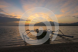 Sunrise with tourist boat and still water on Gili Air Island, In