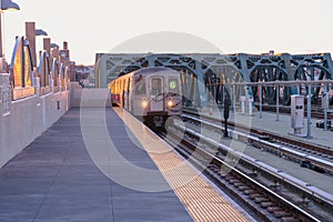 Sunrise on the train platform as the G Train arrives at the Smith Street