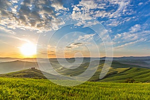 Sunrise in Tuscan with rolling rural landscape in mist