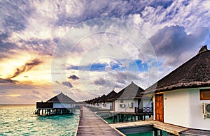 Sunrise of typical luxury overwater villa