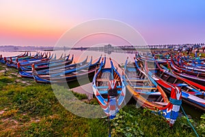 Sunrise at U Bein Bridge with boat, Mandalay, Myanmar.