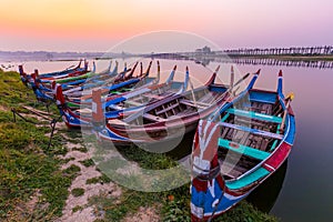 Sunrise at U Bein Bridge with boat, Mandalay, Myanmar.