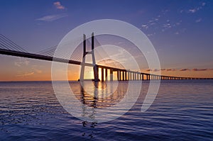 Sunrise at Vasco da Gama Bridge, the longest bridge in Europe, who spans the Tagus River, in Lisbon, Portugal