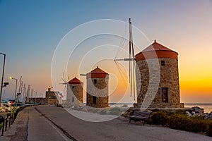 Sunrise view of ancient windmills at the port of Rhodes, Greece
