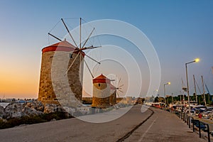 Sunrise view of ancient windmills at the port of Rhodes, Greece