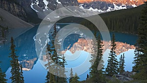 Sunrise view of a calm moraine lake in banff nat`l park, canada